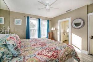 a bedroom with a bed and a ceiling fan at Beautiful Waterfront Beach Cottage. Sleeps 6 in Clearwater Beach