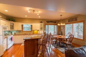 a kitchen and dining room with a table and chairs at Nature's Getaway Mountain Resort- Cozy Bear Cabin in Nordegg