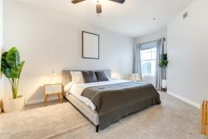 a white bedroom with a bed and a window at LoHi Condo with Balcony 1 Mi to Downtown Denver! in Denver