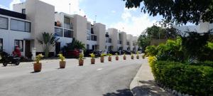 a street with a row of potted plants on the road at Paraíso Casa Turquesa Playa del Carmen in Playa del Carmen