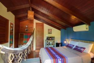 En eller flere senge i et værelse på Pacha - Bangalôs em Pipa
