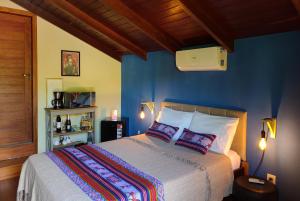 En eller flere senge i et værelse på Pacha - Bangalôs em Pipa