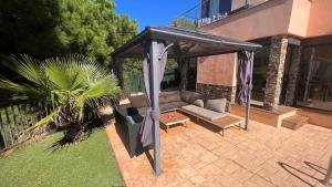 a black canopy over a couch in a backyard at Luxury Villa Marina in Lloret de Mar