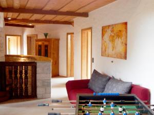 a living room with a red couch and a table at Altmuehl Familienvilla in Treuchtlingen