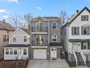 a group of three houses with a driveway at FaithInn - 3 Bed 2 Bath Near EWR/ Downtown/ NYC in Newark