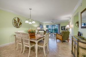 a dining room with a table and chairs at Runaway Bay in Bradenton Beach