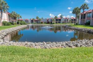 a pond in the middle of a park with condos at Runaway Bay in Bradenton Beach