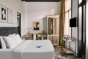 a bedroom with a white bed and a television at Sonder Park House in Amsterdam