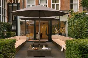 an umbrella sitting on a table in a courtyard at Sonder Park House in Amsterdam