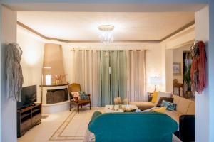 een woonkamer met een bank en een tv bij Villa Marena with extraordinary views in Agios Nikolaos