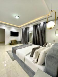 um quarto de hotel com duas camas e uma televisão de ecrã plano em De Fivez em Lagos