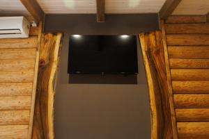 einen Flachbild-TV an der Wand in einem Zimmer in der Unterkunft Wild River in Neporotovo