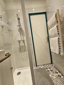 a bathroom with a shower with a glass door at French Luxury Paris in Paris