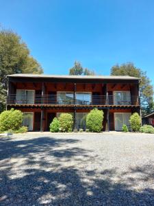 a house with a large driveway in front of it at Verdevida Apart Hotel in Pucón