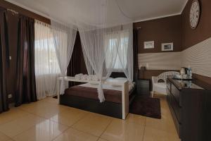 a bedroom with a bed and a dresser in it at Willa Natalia in Zielona Góra