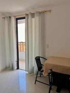 a room with a table and a window with a view at Hotel San Cayetano in Ocaña