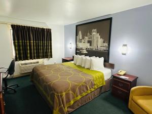 a hotel room with a bed and a window at Super 8 by Wyndham Imlay City in Imlay City