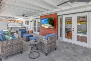 a porch with couches and chairs and a table at Huntington Beach, AC, Pool, Hot Tub, Detached Office, Close to Beach, Outside Entertaining Area in Huntington Beach