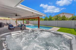a hot tub in the backyard of a house at Huntington Beach, AC, Pool, Hot Tub, Detached Office, Close to Beach, Outside Entertaining Area in Huntington Beach