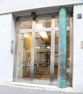 a window of a building with a pole at Meyland suites centro in Milan