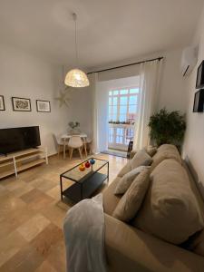 a living room with a couch and a table at Edén Luxury Suites in Granada +7 photos