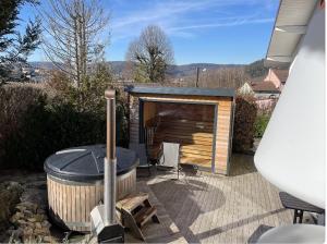 a backyard with a hot tub and a sauna at L'ANNEXE in Saint-Étienne-lès-Remiremont