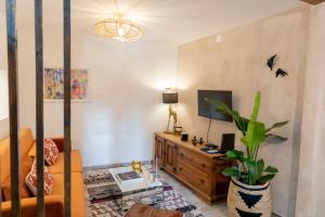a living room with a couch and a tv at Portas da Cidade Home in Silves