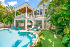 a house with a swimming pool and a resort at Southern Exposure AMV in Anna Maria