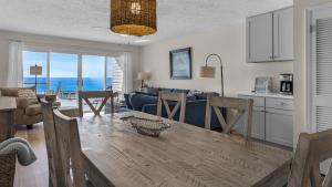 a kitchen and living room with a table and chairs at Blue Nine 5 in Panama City Beach