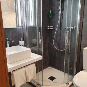 a bathroom with a sink and a shower at Hotel dala in Leukerbad