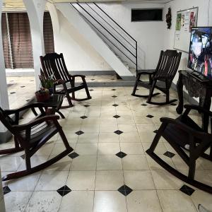 Pokój z 4 fotelami bujanymi i podłogą wyłożoną kafelkami w obiekcie El Callejon Guest House w mieście León