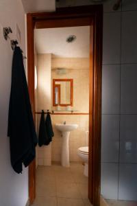 a bathroom with a toilet and a sink at NewStar Duplex in Setúbal