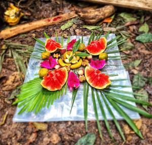 a plate of fruit on top of a palm leaf at Batu Kapal Guest House & Jungle trekking in Bukit Lawang