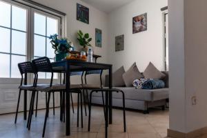 a living room with a table and chairs and a couch at NewStar Duplex in Setúbal