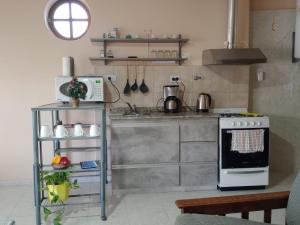 a kitchen with a stove and a microwave at Fava in San Juan