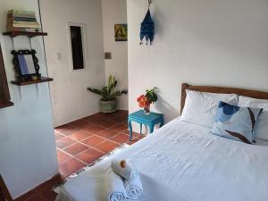a bedroom with a bed with towels on it at Chalé Flor do Ser in Canoa Quebrada