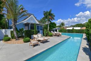 a swimming pool in front of a house at The Gathering Place in Bradenton