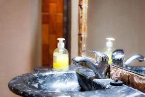 a bathroom sink with two soap bottles on it at Riad Rihana Dades in Boumalne