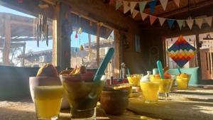 a table with many glasses of drinks on it at Hostal Sisabel in Tinogasta