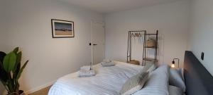 a bedroom with a bed with two pillows on it at Luxueus, ruim appartement op 350m van het strand in Ostend