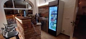 a bar with a refrigerator filled with drinks at Pension Kobr in Vrchlabí