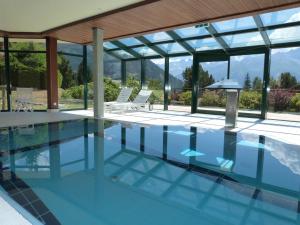 a swimming pool with a view of a house at Hotel Montpelier in Verbier