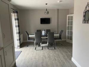 a dining room with a table and chairs at Drumnieve Lodge in Kesh