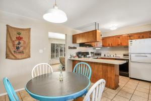 a kitchen and dining room with a table and chairs at Gorgeous Bungalow close to Bushmaster Park! in Flagstaff