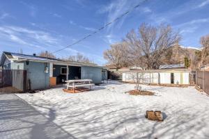 a house with a picnic table in the snow at Gorgeous Bungalow close to Bushmaster Park! in Flagstaff