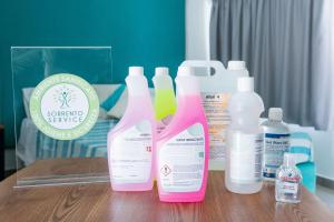 a group of four bottles of cleaner on a table at SorrentoVibes - Deluxe Apartment in Sorrento Centre in Sorrento