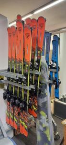 a rack of skis and snowboards on a wall at Pension Kobr in Vrchlabí