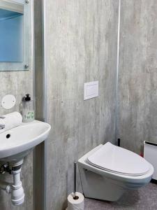 a bathroom with a white toilet and a sink at Stavanger BnB 4 by Sidd in Stavanger +12 photos