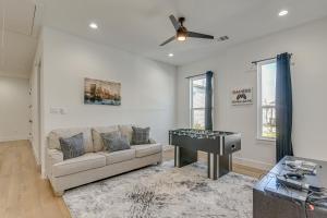 a living room with a couch and a piano at Houston Retreat with Balcony, 1 Mi to Toyota Center! in Houston