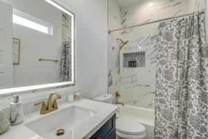 a white bathroom with a sink and a shower at Houston Retreat with Balcony, 1 Mi to Toyota Center! in Houston +17 photos